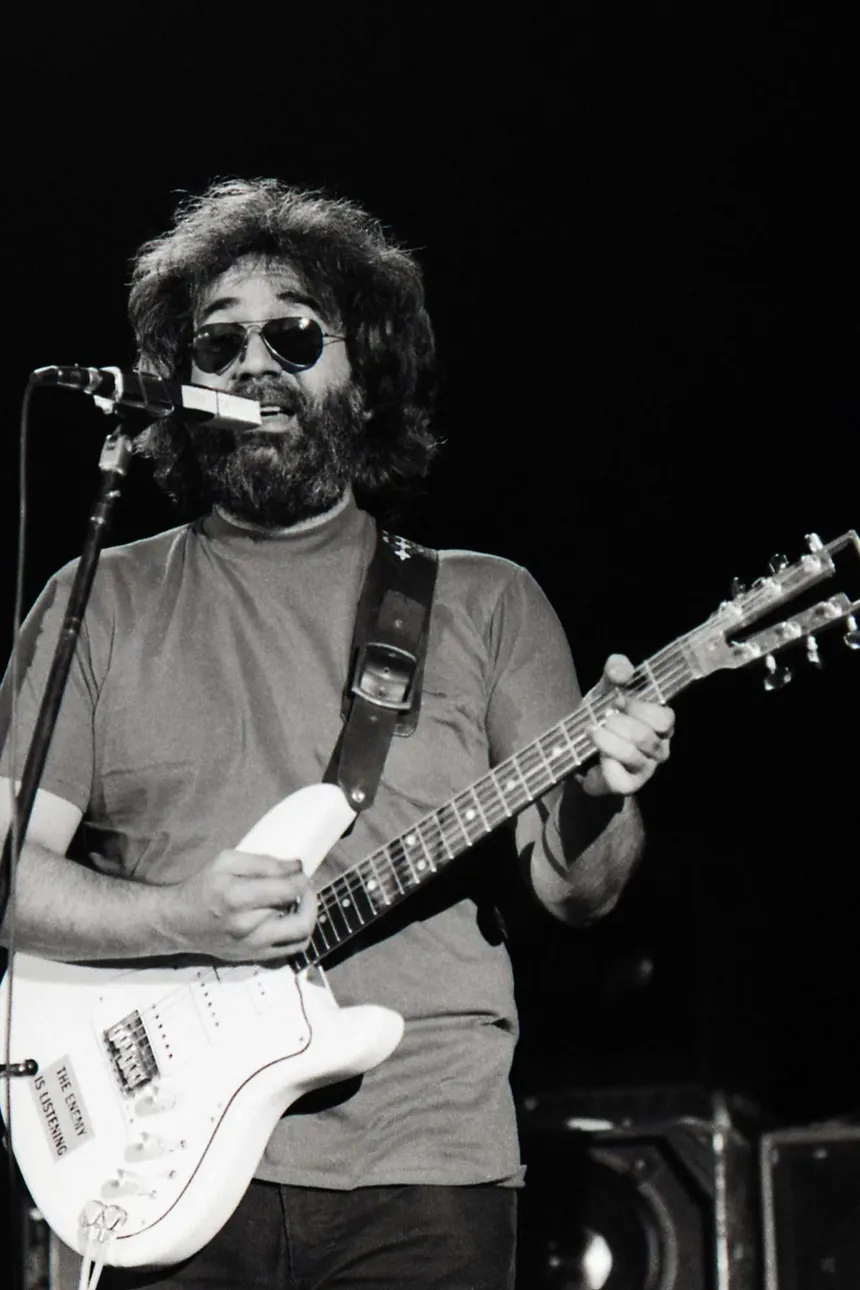 Jerry Garcia on stage with a white Stratocaster, photocopied onto the tape card